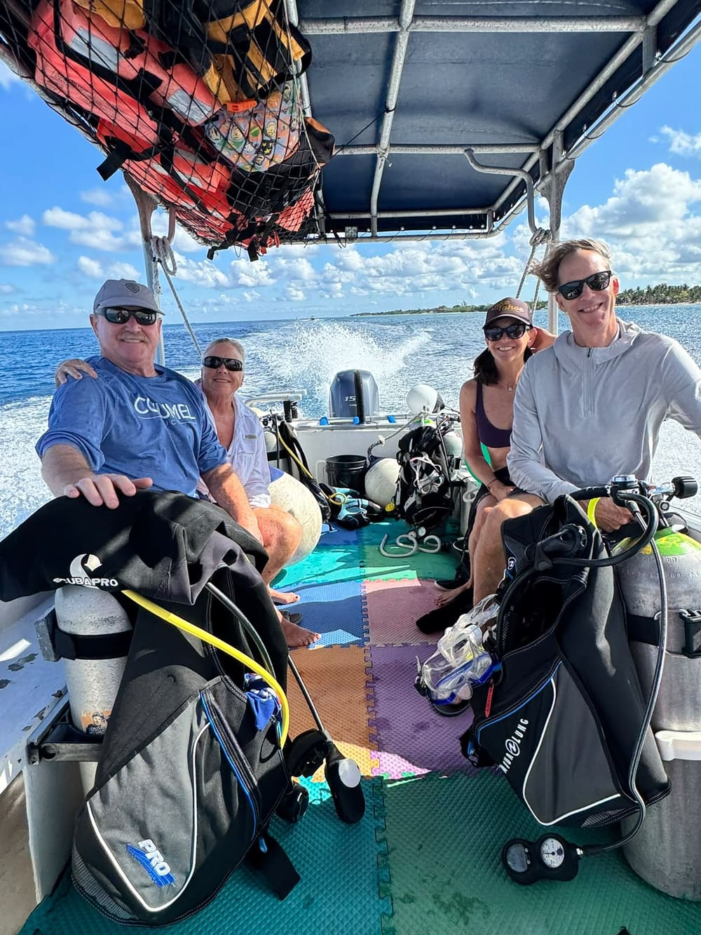 Four guests on the boat heading out along the Cozumel coast